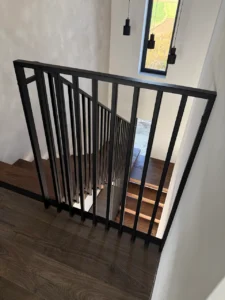 Pionowa balustrada stalowa na spoczniku – czarne barierki lamelowe w nowoczesnym domu Loft Steel Tarnów